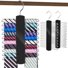 three ties hang on a clothes rack with two clips attached to them and one is black, the other has multicolored stripes