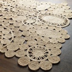 an area rug made out of jute and rope with circles on the top, sitting on a wooden floor