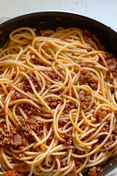 a pan filled with spaghetti and meat sauce