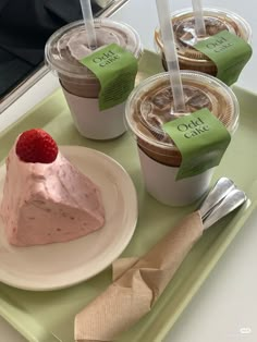 there are three cups with ice cream and a strawberry on the plate next to each other