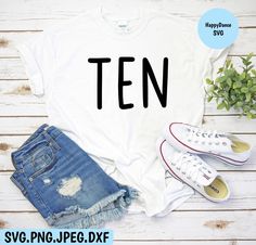 a t - shirt with the word ten on it next to ripped jeans and sneakers