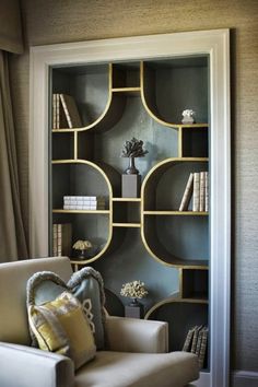 a living room filled with furniture and bookshelves on top of eachother