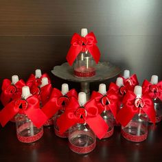 there are many small bottles with red bows on them