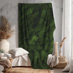 a bed room with a large green blanket on the wall and pillows in front of it