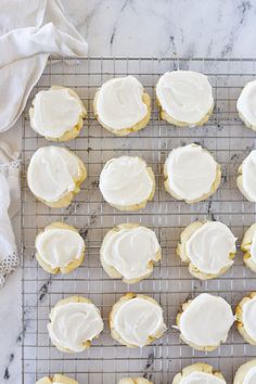 frosted cookies sitting on top of a cooling rack