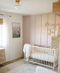 a baby's room with a crib and dresser