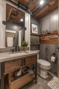 a bathroom with a toilet, sink and shelves in it's centerpieces