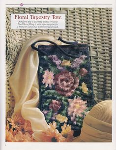 a cross stitch purse with flowers on it