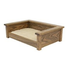 a dog bed made out of wood with a cushion in the middle and bottom section