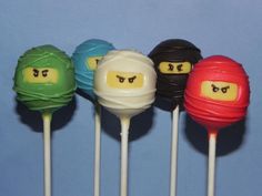 four lollipops with different colored faces on them