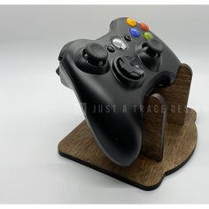 a close up of a controller on a wooden stand