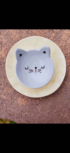 a white plate with a cat face on it