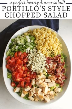 a white bowl filled with pasta salad on top of a table