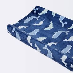 a blue and white whale print blanket on a white background with seagulls all over it