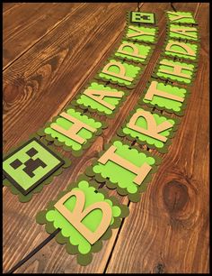 a green happy birthday banner on a wooden table