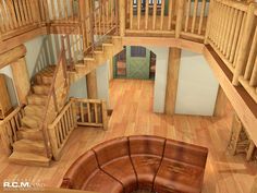 an aerial view of a living room with wood floors and staircases in the center