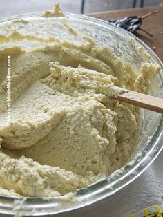 a bowl filled with batter sitting on top of a table