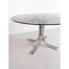 a round glass table with metal legs