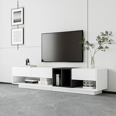 a flat screen tv mounted to the side of a white entertainment center in a living room