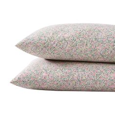 two pillows on top of each other with pink and green speckles in them