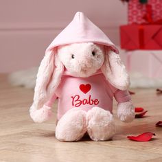 a pink stuffed rabbit wearing a pink shirt with the word bake on it