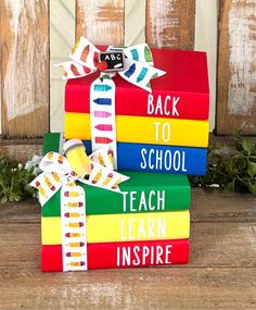 stack of colorful books with back to school written on them and tied up in ribbons