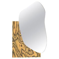 a mirror that is on top of a piece of wood and has been cut out