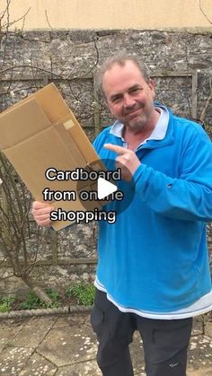 a man holding a cardboard box and pointing to it with the words cardboard from one shopping carton