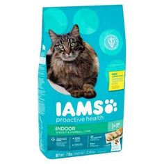 a cat laying down on top of a bag of iamsi indoor dry cat food