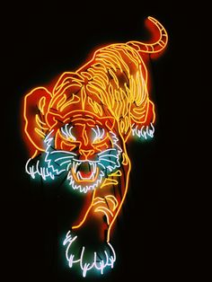 a neon tiger is on display in the dark