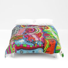 a bed with a colorful comforter on top of it