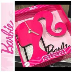 a pink box with the word barbie on it and an image of a clock inside