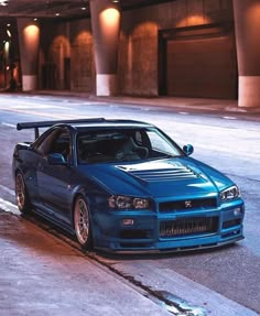 a blue sports car parked on the street