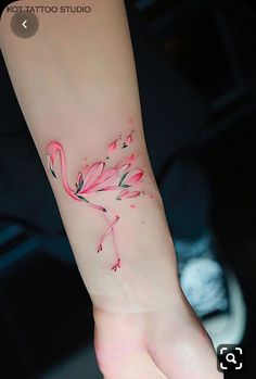 a pink flamingo tattoo on the wrist