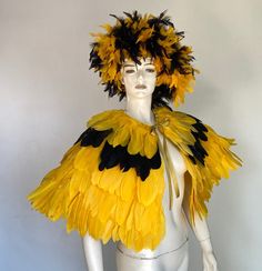 a mannequin dressed in yellow and black feathers