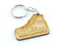 a wooden keychain with a shoe on it that says adore su presencia