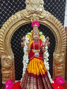 an idol is displayed in front of a backdrop