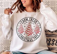 Farm Fresh Christmas Tree Sweatshirt, Christmas Tree Cake T-shirt, Christmas Cake Sweatshirt, Christmas Crewneck, Christmas Shirt For Women 📢Please Check All Photos For Details.   📢Choose Your T-Shirt Size From The Drop-Down Lists Next To The item Picture   📢Choose Of Your T-Shirt Color From The 2nd Picture   📢Use "Add message to Seller" link On The Checkout Page To Send me the Following important Details For Your Order's Customization.   📢Shipping Time Varies by location (we are located in Sugar Land, Texas) please consider that our turn around time is 1 to 3 business days.   ⭐Which brand do you use for t-shirts? We use Gildan Soft Style, Bella Canvas Unisex, Rustic United, Outlash, Tees Factory, Hanes, Comfort Color District and Next Level when we have a shortage of stocks for certa Christmas Tree Cakes, Christmas Tree Cake, Fresh Christmas Trees, Merry Christmas Svg, Tree Cakes, Christmas Gift Idea, Svg Christmas, Diy Shirt, Holiday Shirts