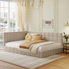 a large bed sitting on top of a hard wood floor next to a white rug