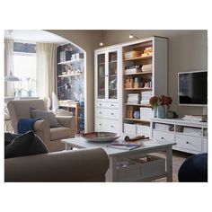 a living room filled with furniture and a flat screen tv on top of a wooden cabinet