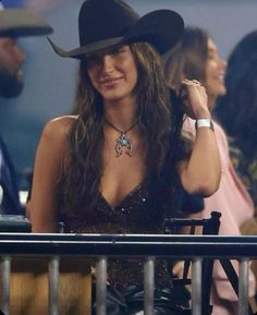 a woman with long hair wearing a cowboy hat