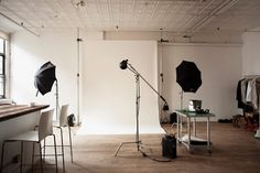 an empty room with several lighting equipment in it