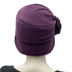 A hat isn't just about fashion, though the bespoke hats found here at Boston Millinery are the height of vintage style, it's about how you feel. It's about finding that finishing touch that make the corners of your lips uptick into a smile that shares your confidence and creativity. The beautiful Alice, our signature design shown in a lovely eggplant fleece. Fleece is a great choice for a winter hat because it is so warm and comfortable. It also makes a great alternative for those who can not or Fitted Cloche Cap For Winter, Elegant Fitted Beanie Hat, Fitted Winter Cloche Cap, Winter Fitted Cloche Hat In Fur Felt, Vintage Fitted Beanie Hat, Winter Flapper Style Brimmed Cloche Hat, Vintage Wool Cloche Hat For Winter, Adjustable Classic Felt Cloche Hat, Vintage Fitted Winter Bonnet