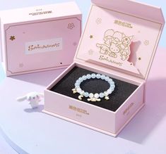 Add a touch of elegance and charm to your accessories collection with the Cinnamoroll Beaded Bracelet. This beautifully crafted bracelet features delicate, light blue beads that capture the whimsical essence of Cinnamoroll. Adorned with golden star and moon charms, along with a cute Cinnamoroll charm, this bracelet is a perfect blend of style and cuteness. Size: 14-17cm Cinnamoroll Bracelet, Cute Cinnamoroll, Star And Moon, Golden Star, Accessories Collection, Moon Charm, Blue Beads, Stars And Moon, Beaded Bracelet