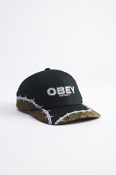 Paneled cotton cap by OBEY with a logo at the front & barbed wire accents. Adjustable fit hat with a strap closure back. Features OBEY Not Right 6-panel hat Paneled cotton cap Patch front Strap closure Content + Care Cotton Spot clean Imported Size Adjustable circumference | OBEY Not Right 6-Panel Hat in Black, Men's at Urban Outfitters Contemporary Graphic, Obey Clothing, Military Design, Panel Hat, Barbed Wire, Cool Hats, Hat Shop, Fitted Hats, And Sign