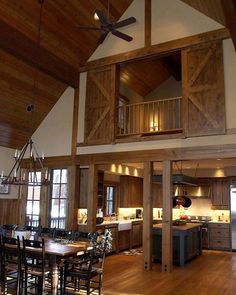 the inside of a house with wood flooring and ceiling fan in it's center