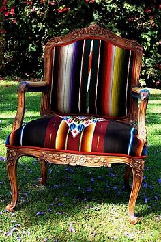 an old wooden chair sitting in the grass