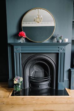 a living room with a fireplace and mirror