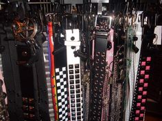 a rack full of assorted belts and bracelets