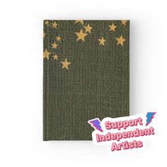 a green notebook with gold stars on it and the words support independent artists in red, white